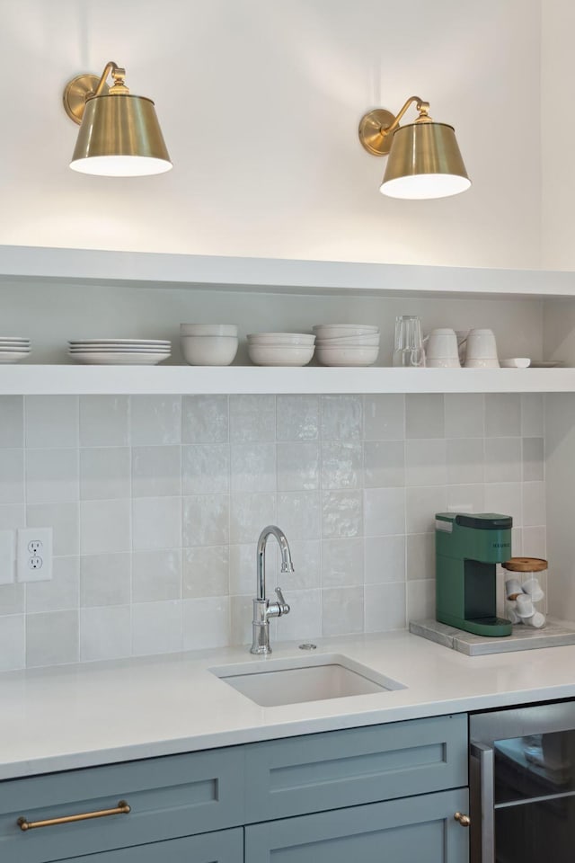 kitchen with beverage cooler, sink, and decorative backsplash