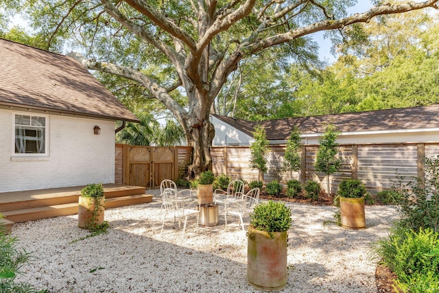 view of yard with a wooden deck and a patio area