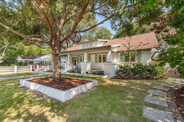 view of front facade with covered porch and a front yard