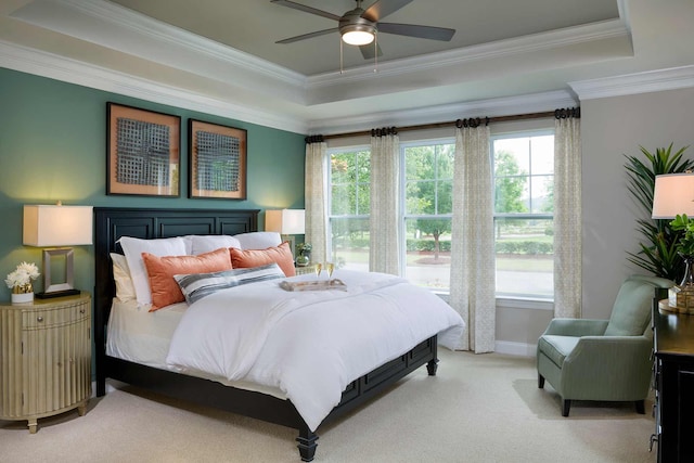 bedroom with ornamental molding, light colored carpet, and a raised ceiling