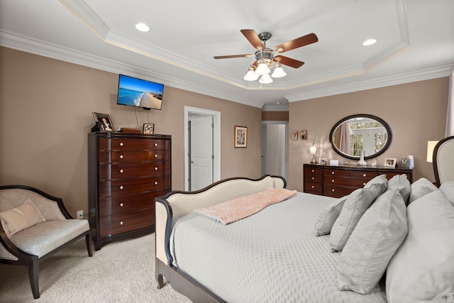 bedroom featuring ceiling fan, a raised ceiling, light colored carpet, and ornamental molding