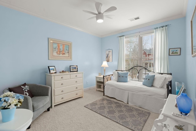 bedroom with visible vents, ornamental molding, a ceiling fan, baseboards, and light colored carpet