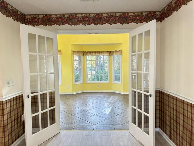 209 Myrtlewood Dr, Santee, SC 29142 - doorway with french doors, tile patterned floors, and baseboards