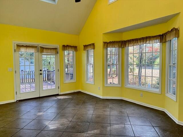 unfurnished sunroom featuring lofted ceiling and french doors