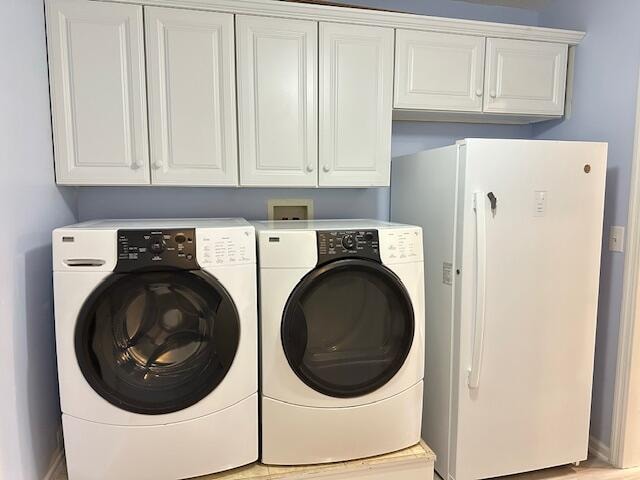 clothes washing area featuring independent washer and dryer