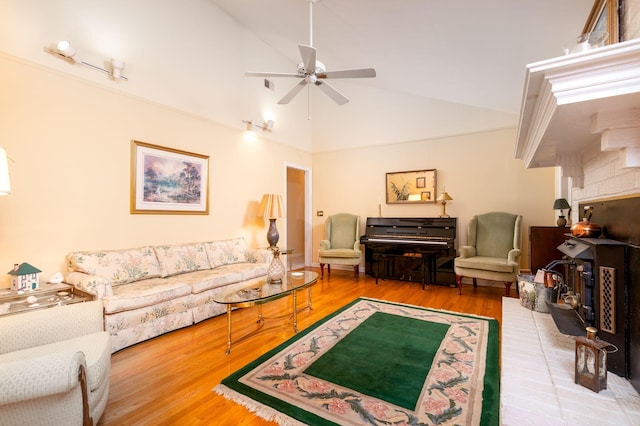 living room featuring ceiling fan, high vaulted ceiling, and hardwood / wood-style flooring