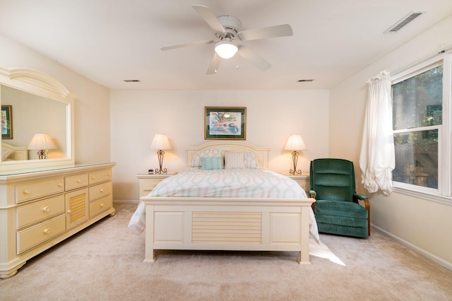 bedroom with ceiling fan and light carpet