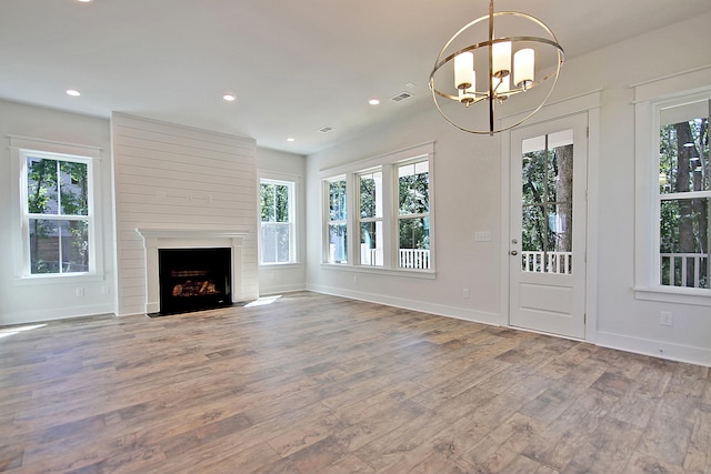 1423 Clay Field Trl, Summerville, SC 29485 - unfurnished living room featuring healthy amount of natural light, wood finished floors, a chandelier, and recessed lighting