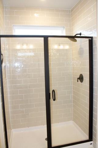 bathroom featuring a shower with door