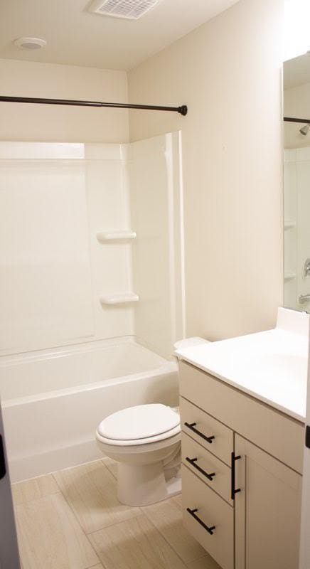 full bathroom with shower / bathtub combination, toilet, and vanity