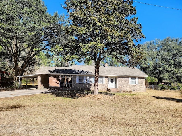 ranch-style home with a front lawn and a carport