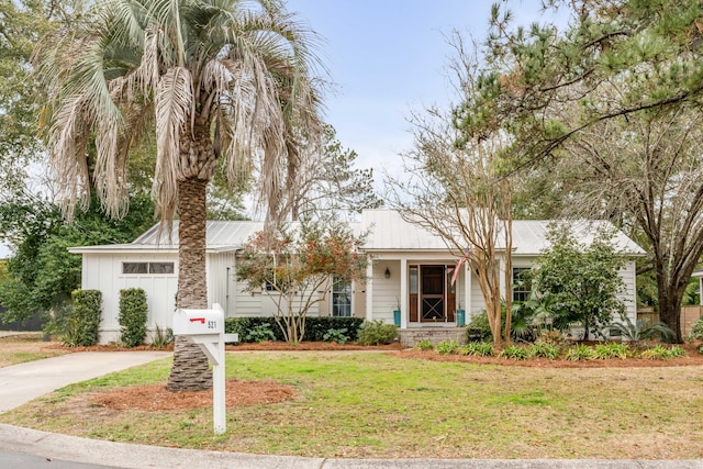 view of front of property with a garage and a front yard