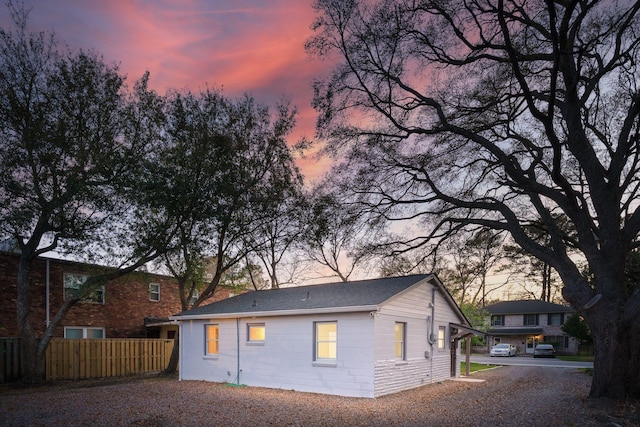 rear view of property featuring fence
