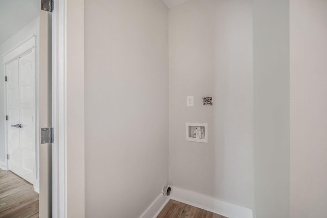 laundry area with washer hookup, baseboards, wood finished floors, and laundry area