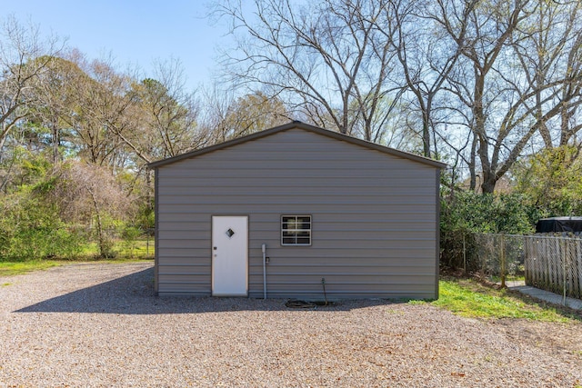 view of outbuilding with an outdoor structure and fence