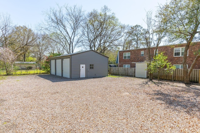 exterior space with fence and an outbuilding