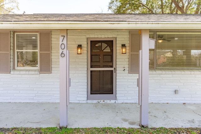 entrance to property featuring brick siding