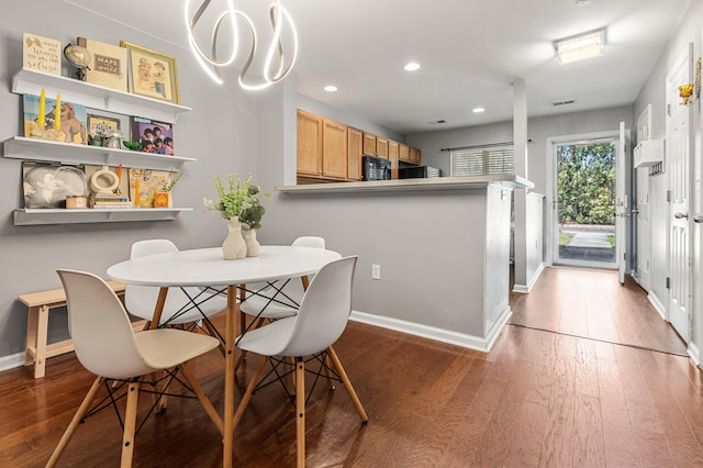 dining room with recessed lighting, visible vents, baseboards, and wood finished floors