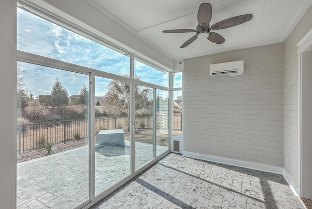 sunroom featuring a wall mounted air conditioner and ceiling fan