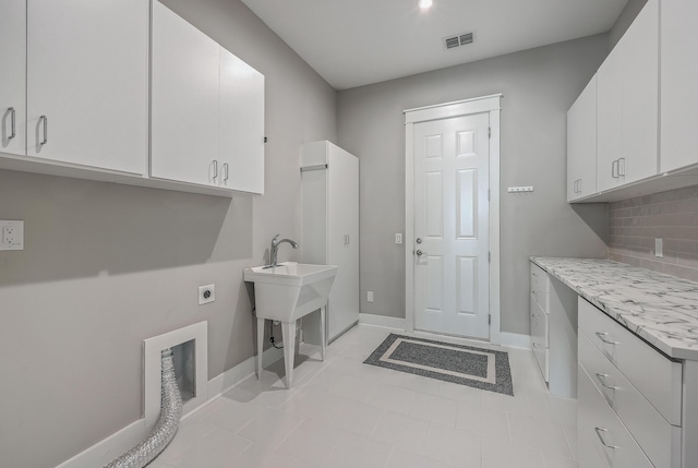 laundry room featuring cabinets and hookup for an electric dryer