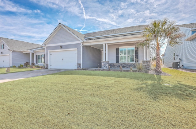 ranch-style home featuring a garage, a front lawn, and central air condition unit