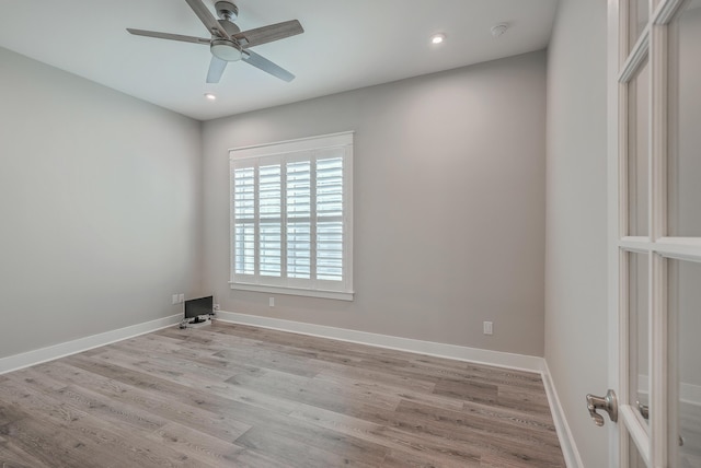 spare room with ceiling fan and light hardwood / wood-style floors