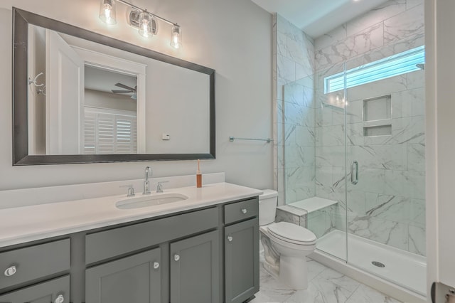 bathroom with vanity, an enclosed shower, ceiling fan, and toilet