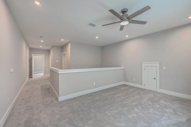 unfurnished room with ceiling fan and light colored carpet