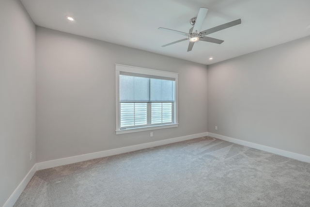 unfurnished room featuring light carpet and ceiling fan