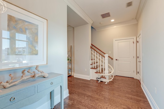 foyer entrance featuring hardwood / wood-style flooring and crown molding