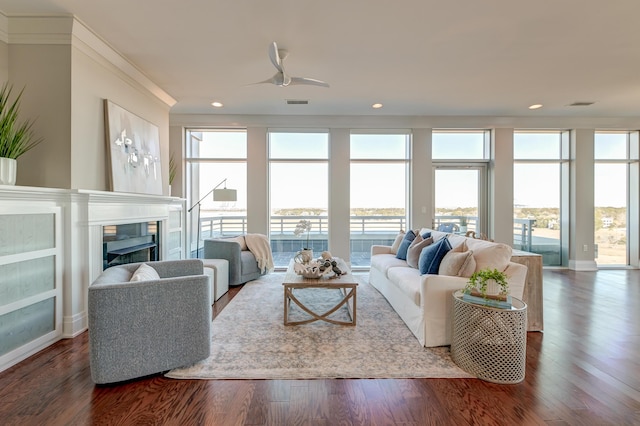 living room featuring ceiling fan, hardwood / wood-style floors, and crown molding