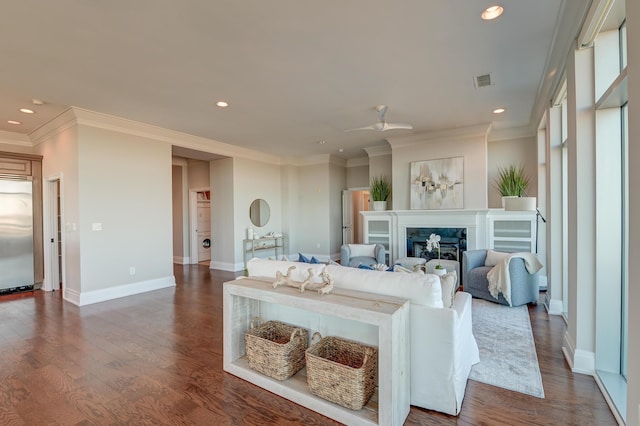 living room with a premium fireplace, ceiling fan, dark hardwood / wood-style floors, and ornamental molding