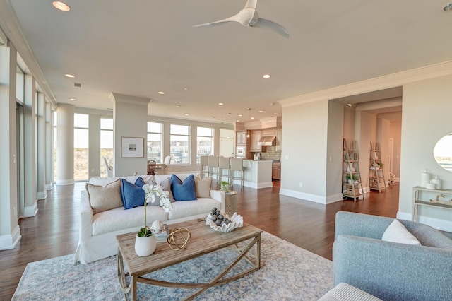 living room featuring dark hardwood / wood-style floors, ceiling fan, and ornamental molding