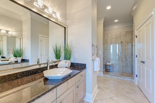 bathroom with tile patterned floors, crown molding, vanity, and walk in shower