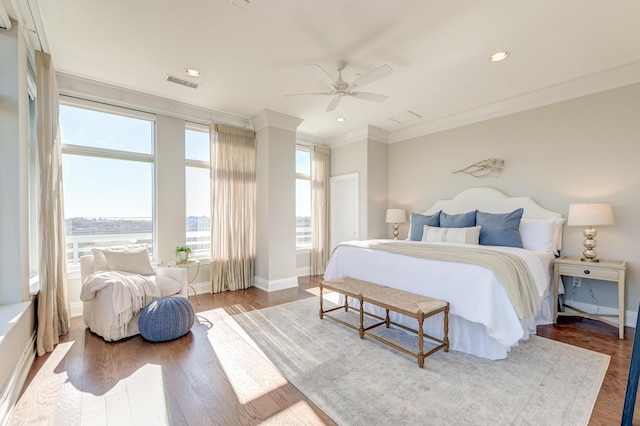 bedroom featuring ceiling fan, wood-type flooring, and ornamental molding