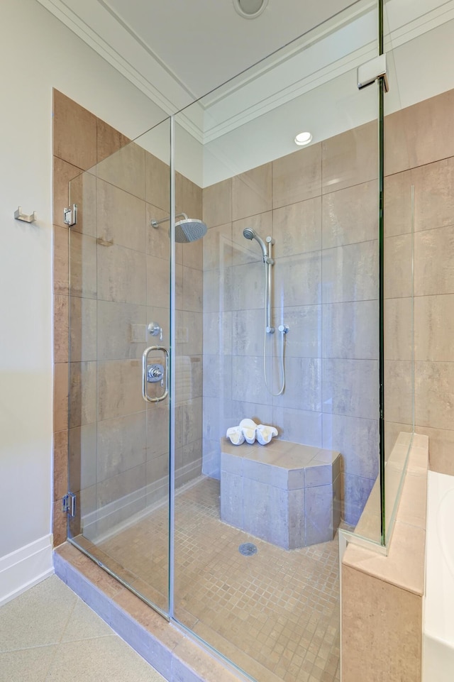 bathroom with tile patterned flooring, an enclosed shower, and crown molding