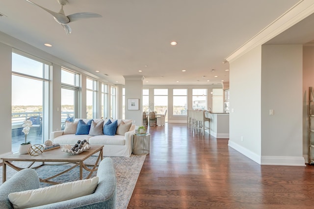 living room with ceiling fan, dark hardwood / wood-style flooring, and crown molding