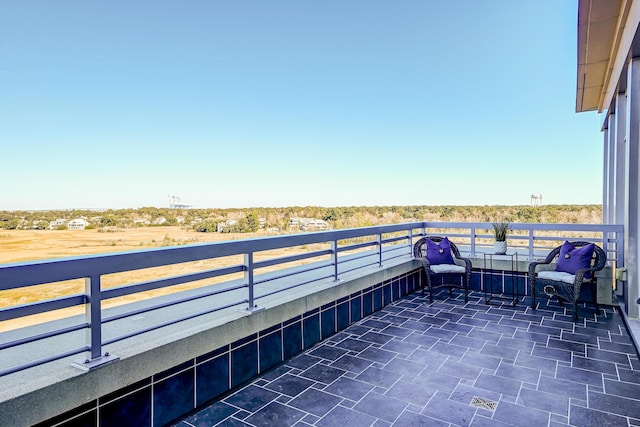 view of patio featuring a balcony