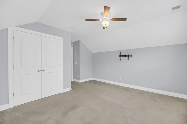 bonus room featuring lofted ceiling, carpet, visible vents, and baseboards