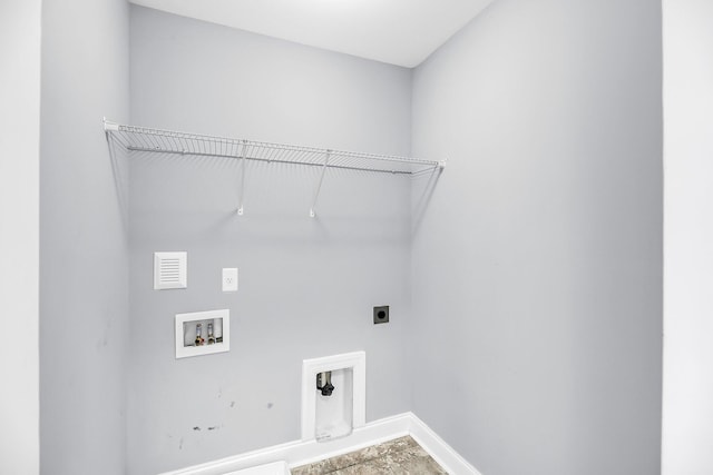 laundry area with laundry area, baseboards, visible vents, washer hookup, and electric dryer hookup