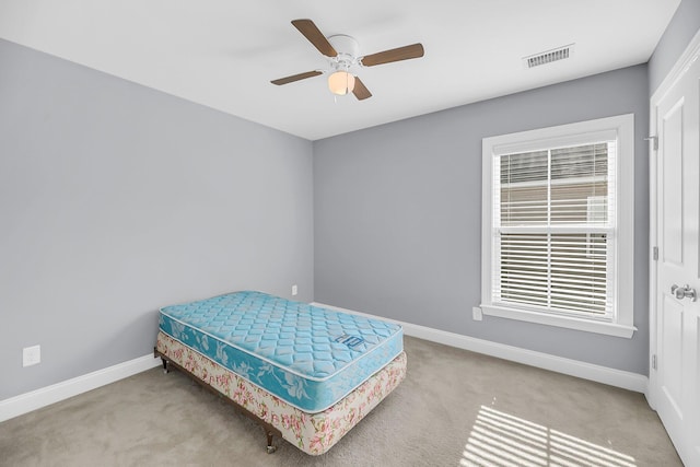 bedroom with carpet floors, baseboards, visible vents, and a ceiling fan