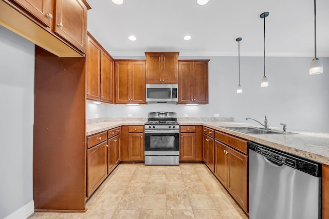 kitchen with pendant lighting, brown cabinets, stainless steel appliances, light countertops, and a sink