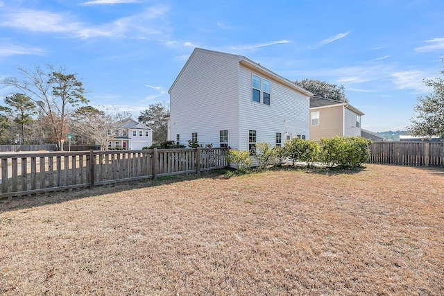 view of home's exterior featuring fence private yard and a yard