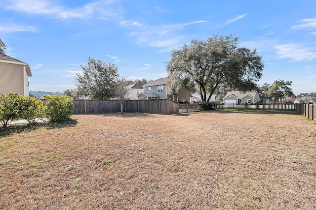 view of yard with a residential view and a fenced backyard