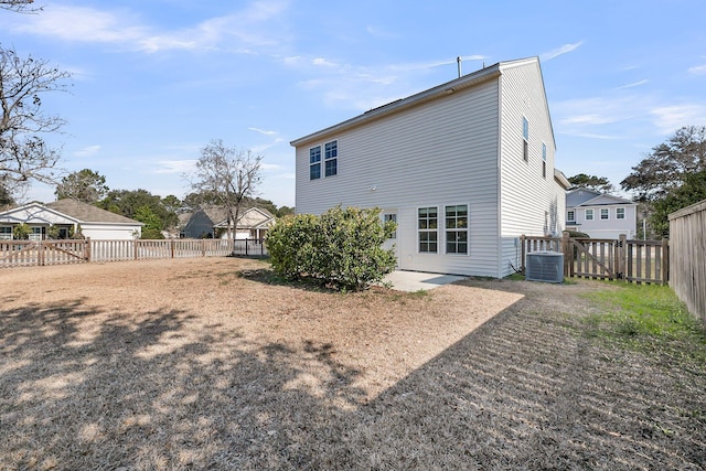 back of house featuring a fenced backyard, a patio, and central AC