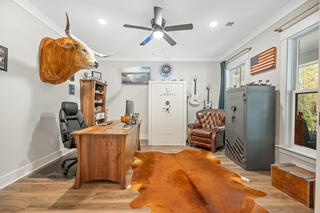 office space with ornamental molding, light wood-type flooring, and ceiling fan