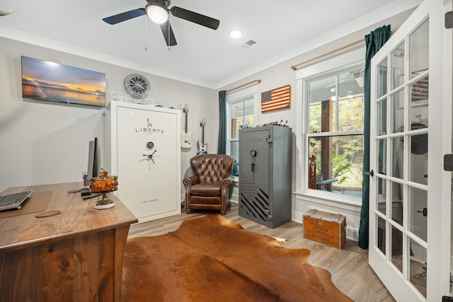 home office featuring crown molding, light wood-type flooring, and ceiling fan