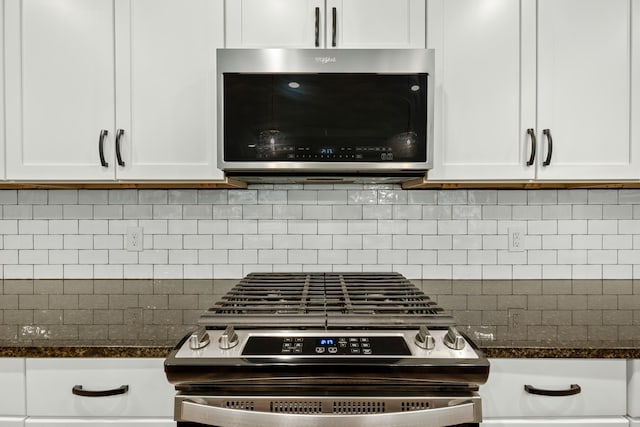 details featuring white cabinets, tasteful backsplash, stainless steel appliances, and dark stone counters