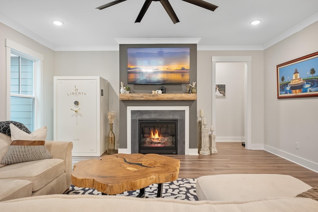 living room with ornamental molding, hardwood / wood-style floors, and ceiling fan