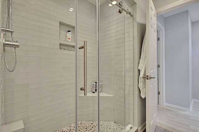 full bath with wood finished floors and a shower stall